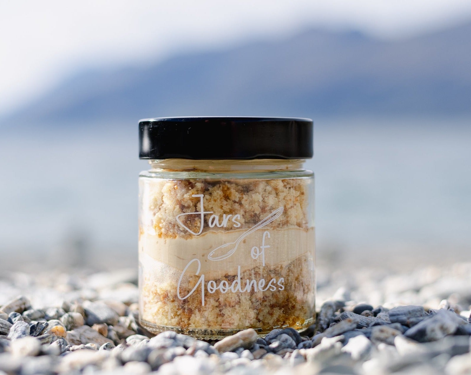 Glass jar filled with layers of cake soaked in coffee and coffee cream.